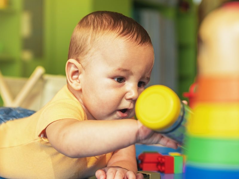 happy-baby-playing-with-toy-blocks-in-the-kindergarten-.jpg